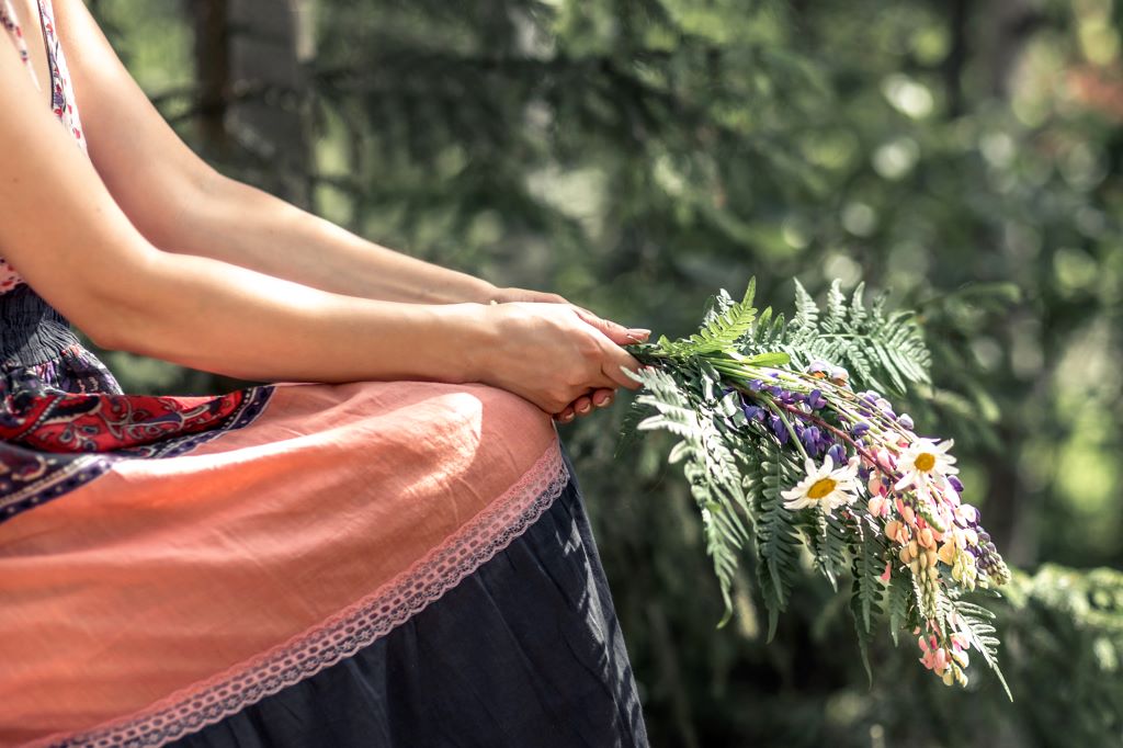 Woman holding flowers at a green funeral
