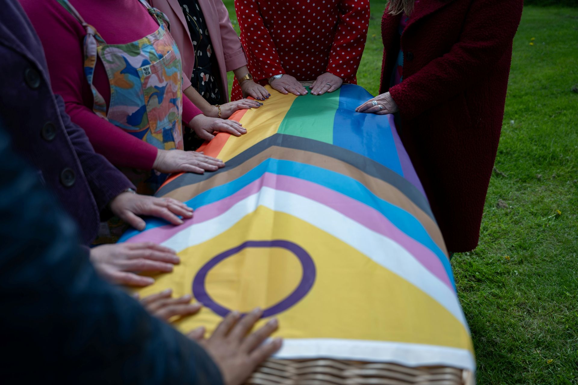 Coffin covered with a colourful pride flag